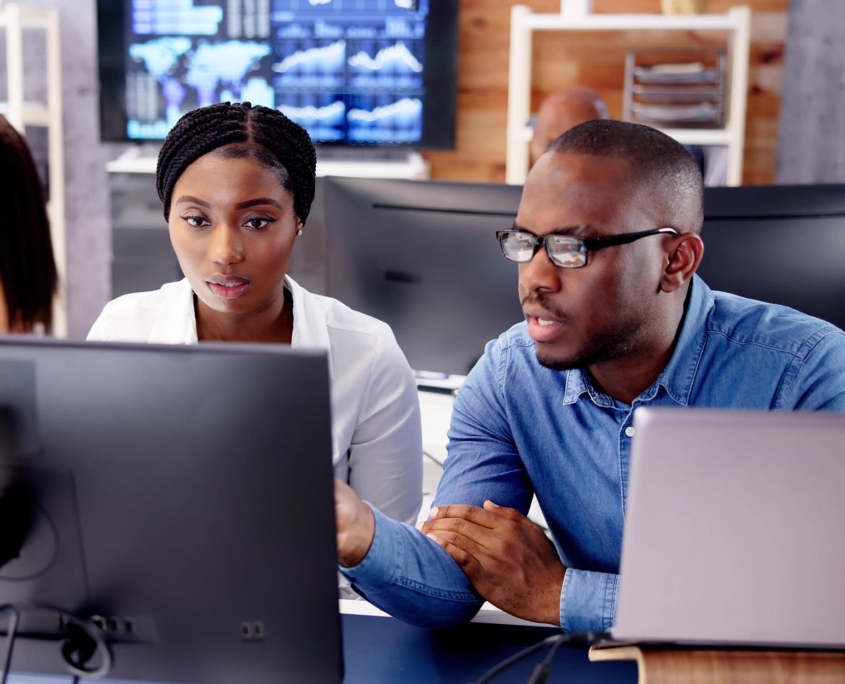 Side view of a man and woman working together on a computer