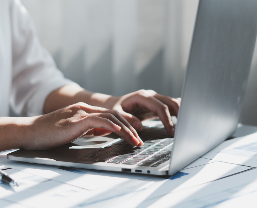 Close up of businessman or accountant working on laptop computer for calculate business data