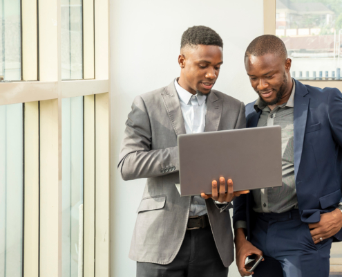 Side view of two men at laptop