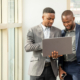 Side view of two men at laptop