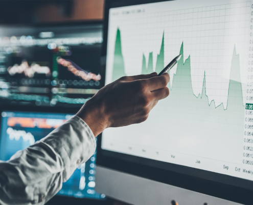 Side view, analyzing financial data on computer screen