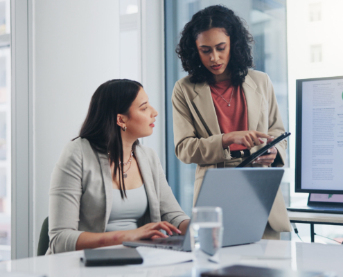 workers in accounting looking at laptop