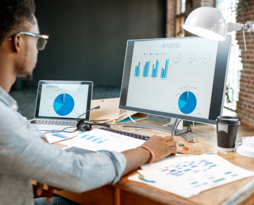 business person looking at financial charts on computer