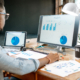 business person looking at financial charts on computer
